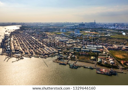 Top view aerial of Cat Lai container harbor, center Ho Chi Minh City, Vietnam with development buildings, transportation, energy power infrastructure.