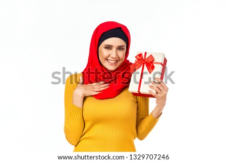   joyful arab woman with gift on isolated background                             