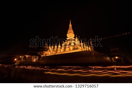 Phra That Luang (Golden Pagoda) at the candle light at night, Laos, Vientiane