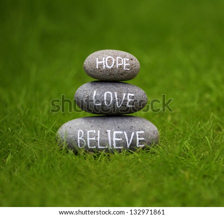 Believe, hope and love rock in the grass