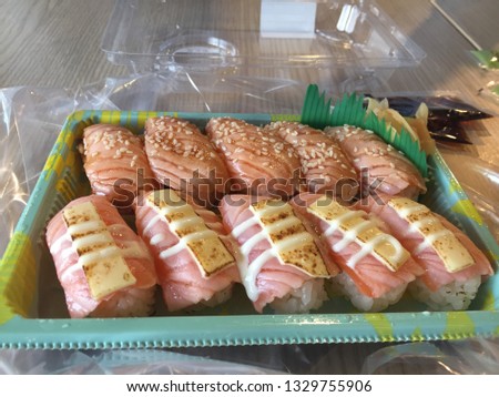Sushi is my favorite food. It seems to me my kryptonite. I also love salmon and cheese. Anyway, I cannot eat raw fish, so I bought burnt salmon sushi. I really enjoy it. Royalty-Free Stock Photo #1329755906
