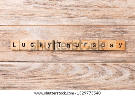 lucky thursday word written on wood block. lucky thursday text on wooden table for your desing, concept.