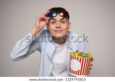  man in the cinema with popcorn                              