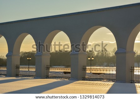 Velikiy Novgorod. Trade rows of the  Yaroslav's court in the evening before sunset. Historical monument of architecture. Winter view on a sunny day Royalty-Free Stock Photo #1329814073