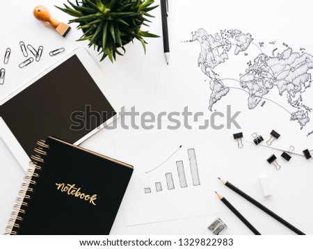 Business background with different office supplies and sketches and notes on white table