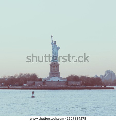Amazing picture of American symbol Statue of Liberty silhouette in New York, USA. Low contrast color image.