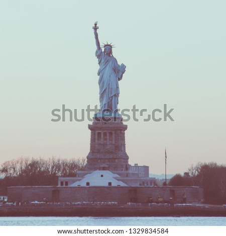 Amazing picture of American symbol Statue of Liberty silhouette in New York, USA. Low contrast color image.