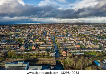 Aerial view of Meir Hay, Longton in Stoke on Trent, Staffordshire, middle class housing estates, St James church and factories in the surrounding area, big fluffy clouds in the sky