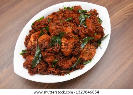 Chicken tikka kebab or chicken 65 hot and spicy dish garnished with curry leaves Kerala. a popular authentic roasted dish deep fried in coconut oil  South India. fried in a coating of Indian spices.. 
