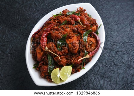 Chicken tikka kebab or chicken 65 hot and spicy dish garnished with curry leaves Kerala. a popular authentic roasted dish deep fried in coconut oil  South India. fried in a coating of Indian spices.. 