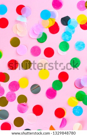 Festive party holiday colorful confetti on pink background. 