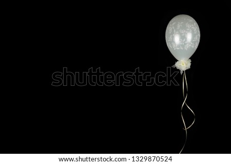 Decorative white / pink balloon with flower print and gold ribbon on black background - pink and white balloon - use for birthday party wedding babyparty flyer background 