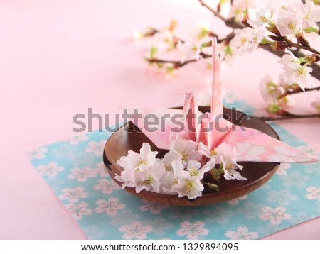 japanese origami crane and sakura flowers (cherry blossom flowers) for hanami festival