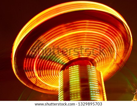The lights on the carousel in motion .