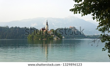 Picturesque view over Lake Bled, Julian Alps mountains and church on the island, sunny day, Bled, Slovenia