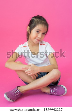 Asian child girl on pink background