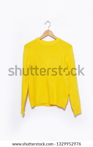 
Close up yellow sweater with on hanging
