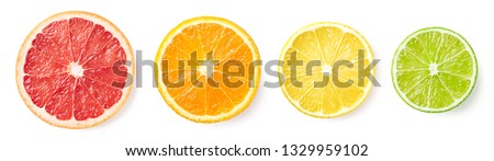 Colorful citrus fruit slices isolated on white background, top view. Grapefruit, orange, lemon and lime Royalty-Free Stock Photo #1329959102