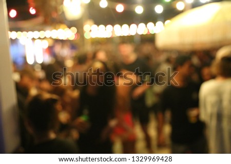 Blurred background of many people had fun at a beach party. Festive concept.
