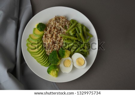 Green detox food. Salad bowl with quinoa and green vegetables - green peas, avocado, broccoli and eggs.
