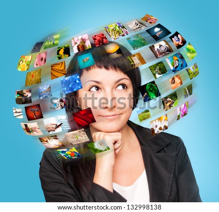 A technology woman has images around his head. Use it for a communication or tv concept. Royalty-Free Stock Photo #132998138