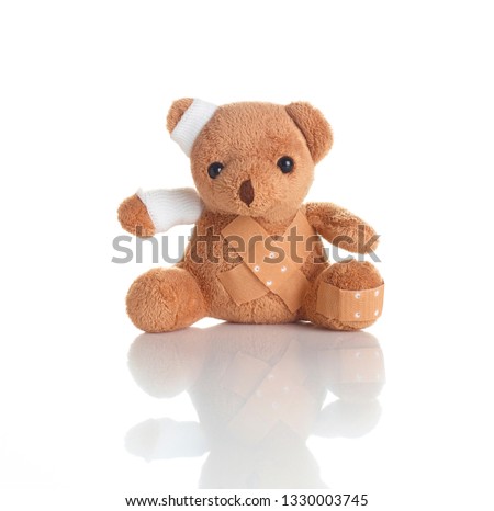 injured teddy bear on white background