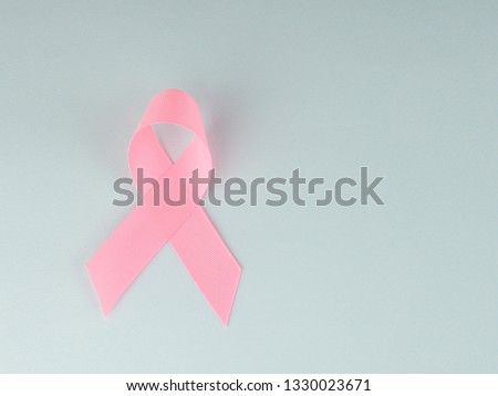 Pink ribbon on blue background. Breast cancer awareness concept.