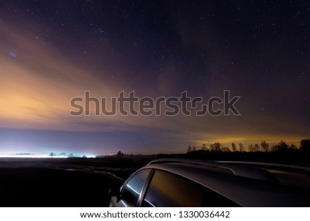 road at night in the countryside with stars in the sky