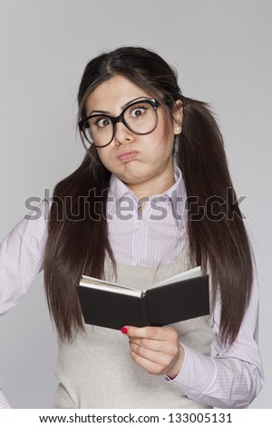 Young bored nerd woman studying on white background