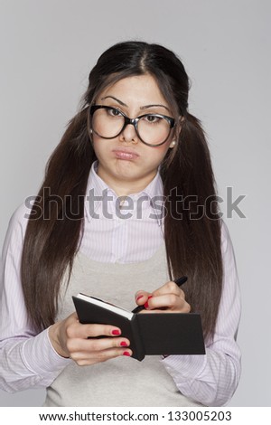 Young bored nerd woman writing on white background