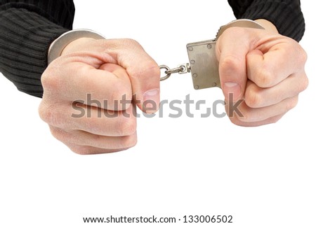Hands in handcuffs squeezed in a fist.