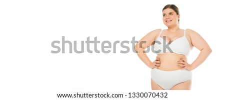 smiling overweight woman in underwear posing with hands on hips, body positivity concept
