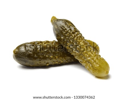 Appetizing salted cucumbers on white isolated background. Close-up. Side view.