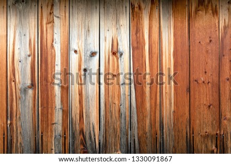 Wooden wall of brown boards with the image of the muzzle of the animal.