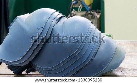 Protective welding mask helmet on the wooden table