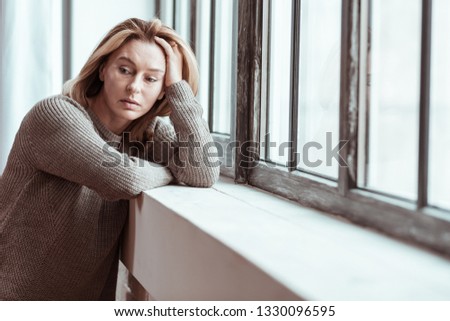 Feeling thoughtful. Pleasant mature woman feeling thoughtful having some personal problems Royalty-Free Stock Photo #1330096595