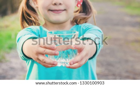 child glass of water. selective focus. Kids.