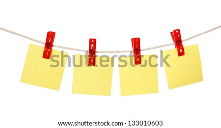 yellow stickers hang on red clothespin (clothesline) isolated on white background