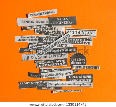Jobs or careers concept: multiple job titles or occupations cut off from newspaper with Immediate Vacancies on top of the pile and on orange background