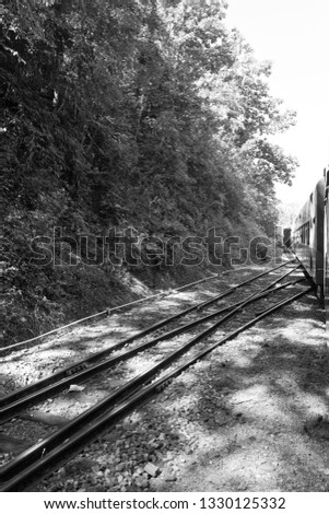 Black and white picture of the old burmese railways with local vegetation on the moutains close to Kalaw, Myanmar