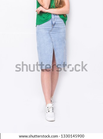 female in green shirts and jeans skirt with white shoes -white background



