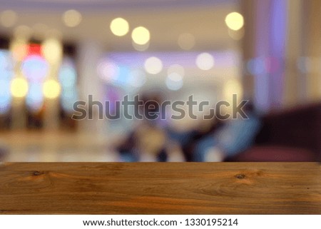 Empty dark wooden table in front of abstract blurred bokeh background of restaurant. can be used for display or montage your products.