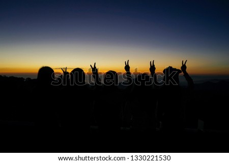 Silhouette of Group of Friends traveling and watching Sunrise together