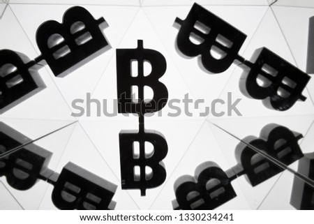 Bitcoin Currency Symbol With Many Mirroring Images of Itself on White Background