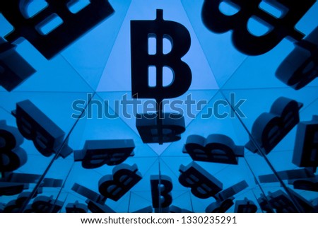 Bitcoin Currency Symbol With Many Mirroring Images of Itself on Blue Background