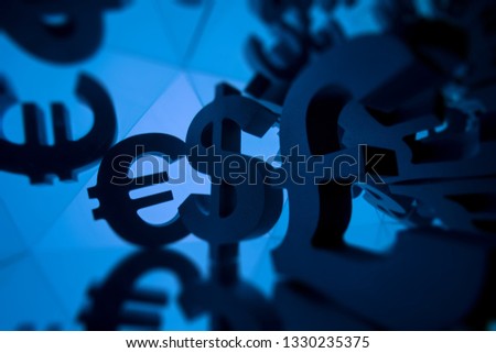 Euro, Pound and Dollar Currency Symbol With Many Mirroring Images of Itself on Blue Background