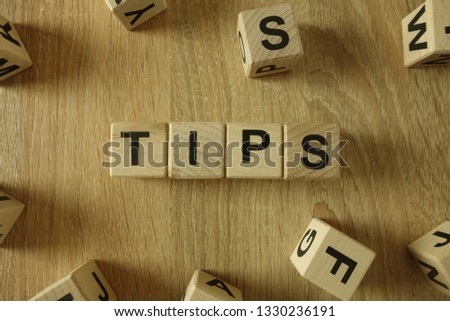 Tips word from wooden blocks on desk