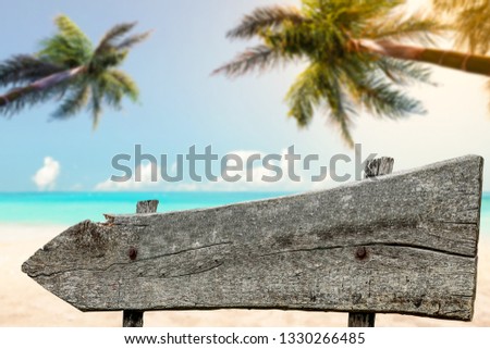 Wooden signpost and sumer time background 