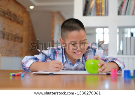 little asian kid boy child schoolboy drawing picture. children leisure activity at home