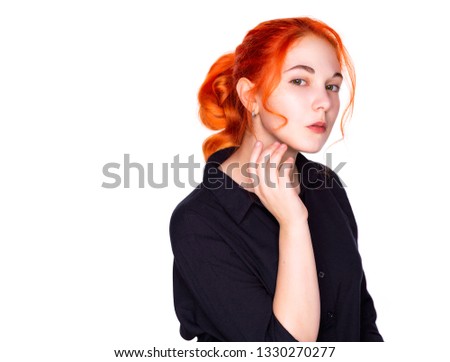 Portrait of a young teen red hair and green eyes girl with clean fresh skin touch own face applying face cream. Facial treatment. Cosmetology , beauty and spa isolated on white background